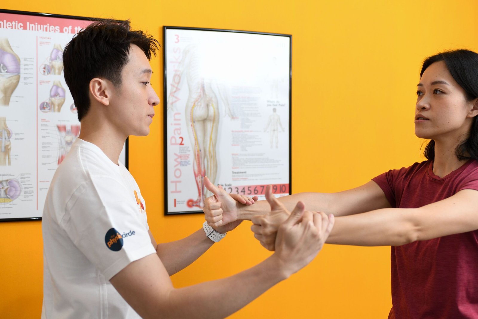 Physio pushing down on patient’s hand