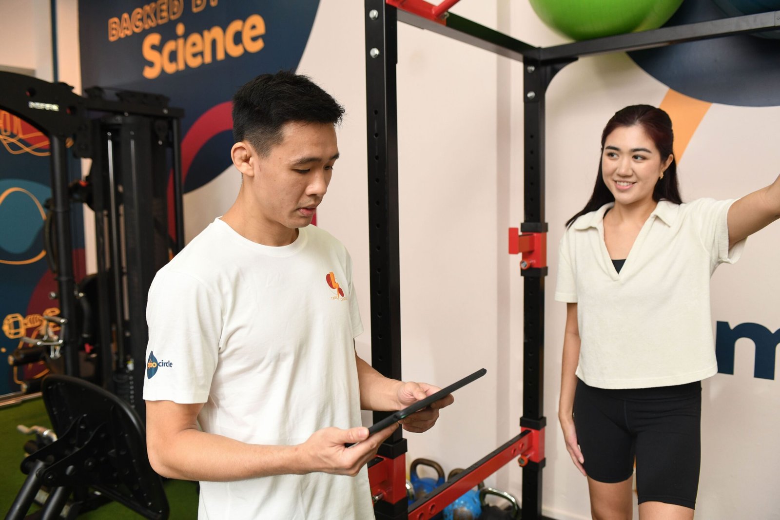 physio in the gym area, patient doing an exercise